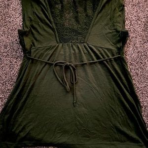 Woman’s hunter green shirt.